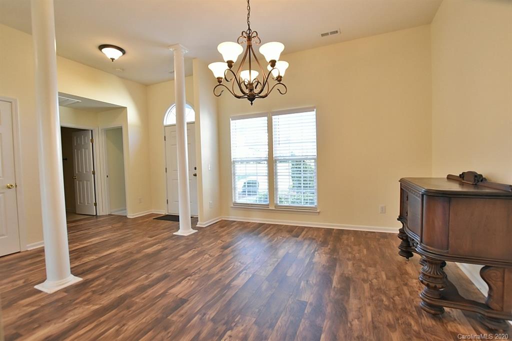 1132 Gower Street Fort Mill, SC 29708 - Photo 3 of 27 a view of an empty room with wooden floor and a window
