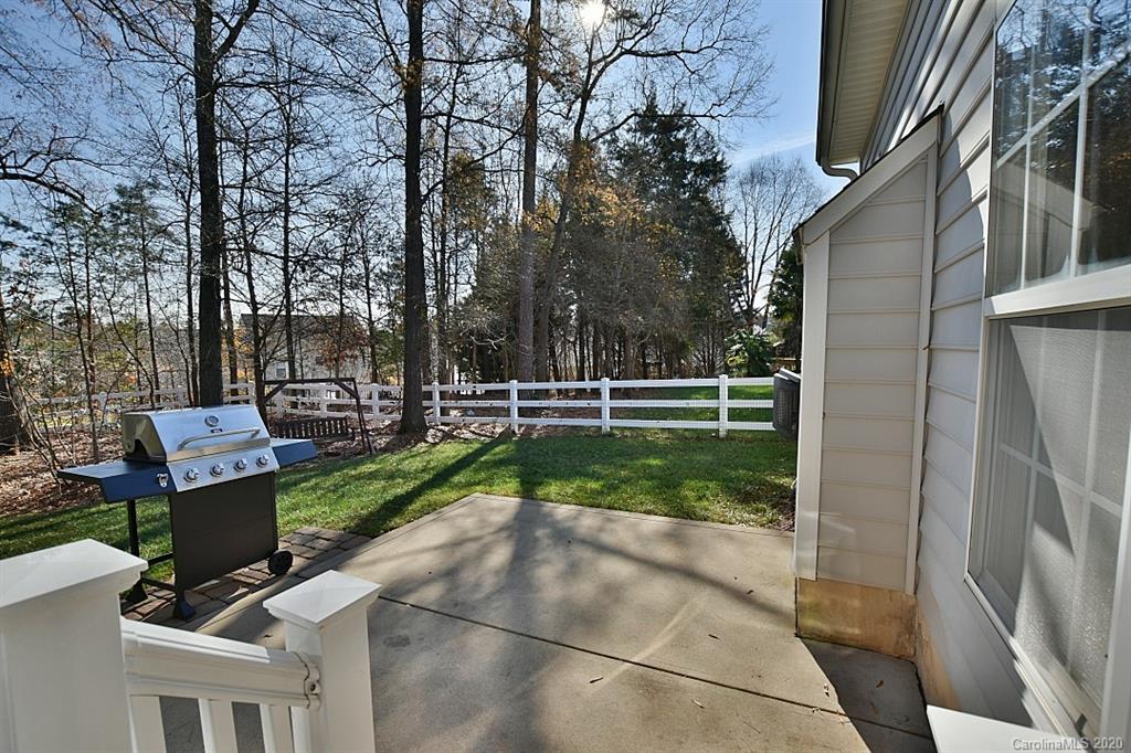1132 Gower Street Fort Mill, SC 29708 - Photo 23 of 27 a view of a chair and tables in the back yard of the house