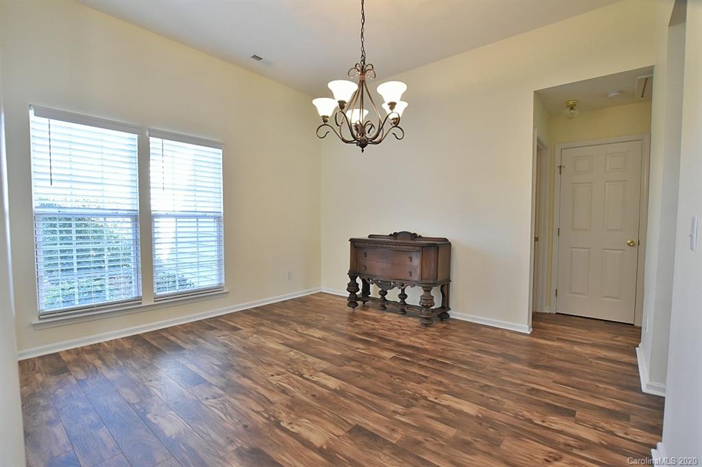1132 Gower Street Fort Mill, SC 29708 - Photo 4 of 27 a view of a dining room with furniture wooden floor and a chandelier