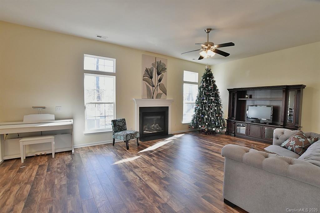 1132 Gower Street Fort Mill, SC 29708 - Photo 6 of 27 a living room with furniture a fireplace and a flat screen tv