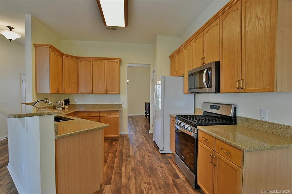 1132 Gower Street Fort Mill, SC 29708 - Photo 9 of 27 a kitchen with stainless steel appliances granite countertop a stove a sink and a microwave