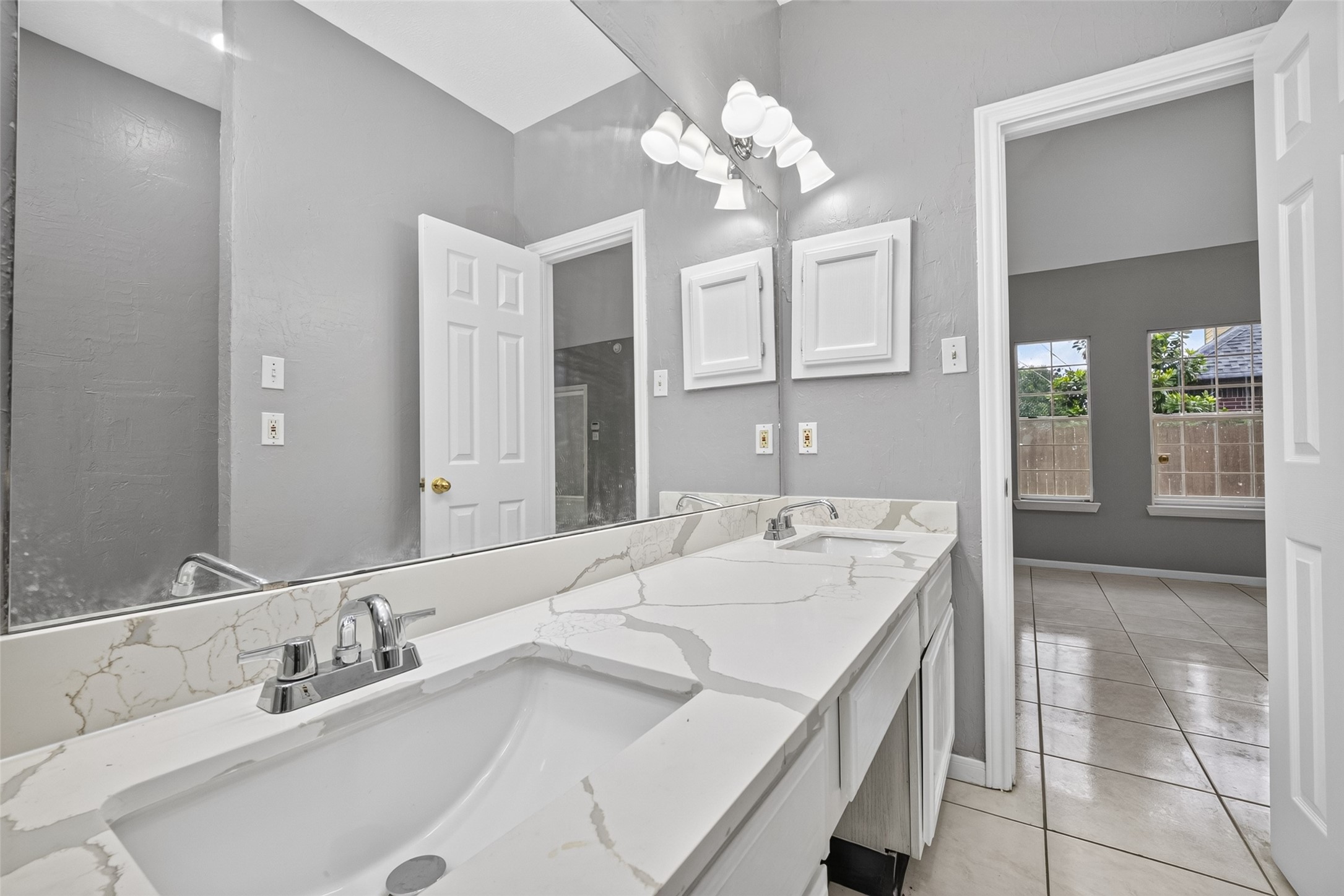 13607 Sable Lane Houston, TX 77014 - Photo 27 of 46 a spacious bathroom with a sink and a mirror