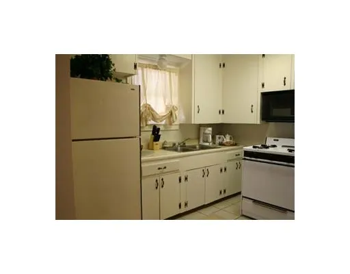 a kitchen with a refrigerator and a stove
