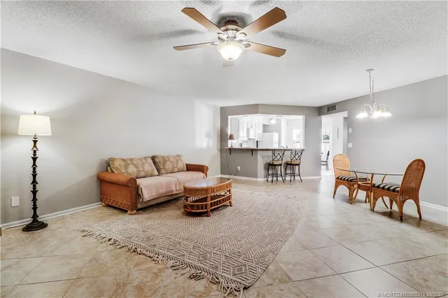 a living room with furniture and kitchen view
