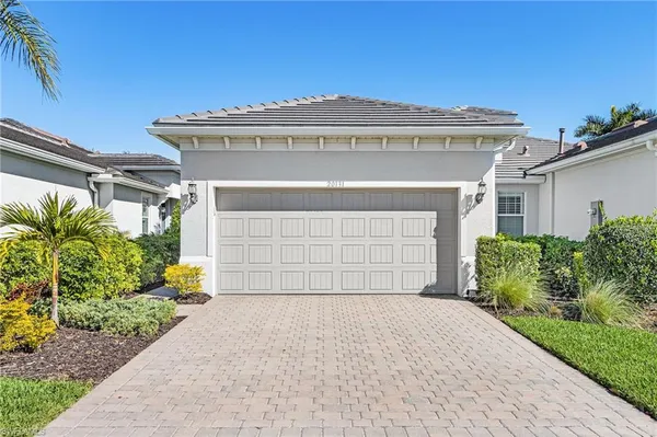 a front view of a house with a yard and garage