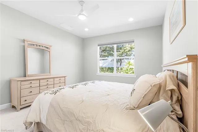 a bedroom with a bed and a mirror