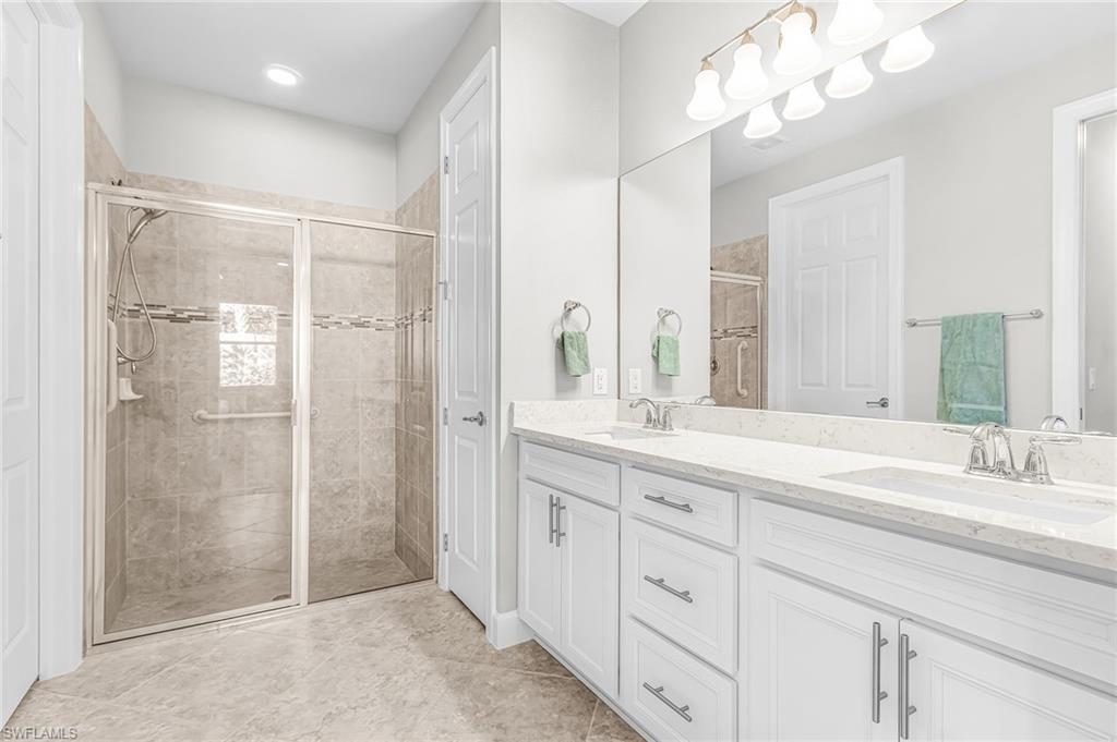 20131 Torch Key Way Estero, FL 33928 - Photo 21 of 47 Bathroom with double vanity and a stall shower