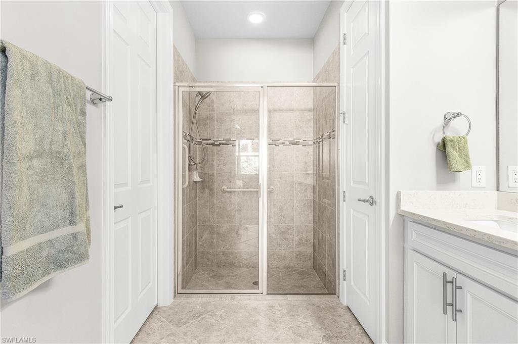 20131 Torch Key Way Estero, FL 33928 - Photo 22 of 47 Bathroom featuring a stall shower and vanity