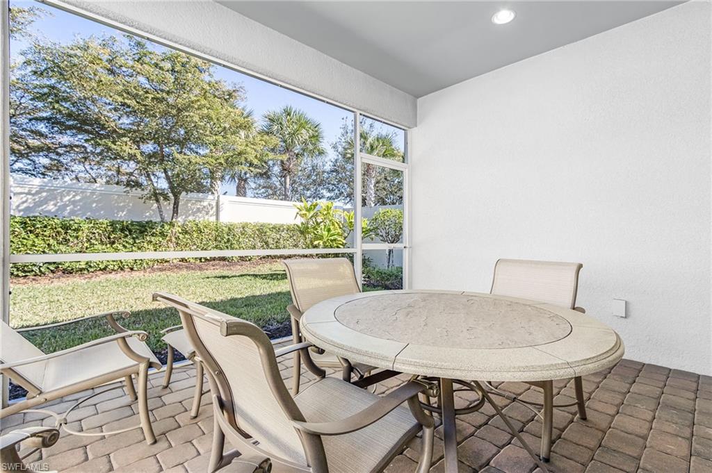 20131 Torch Key Way Estero, FL 33928 - Photo 27 of 47 Sunroom with recessed lighting, a textured wall, and brick patterned flooring