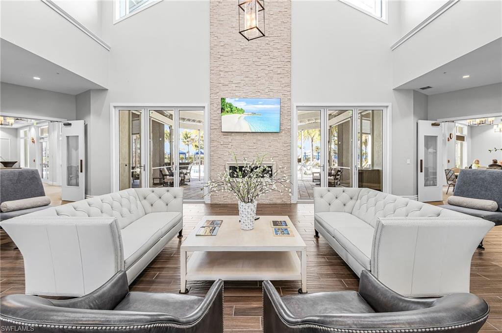 20131 Torch Key Way Estero, FL 33928 - Photo 32 of 47 Living room with french doors, wood finished floors, healthy amount of natural light, and a high ceiling