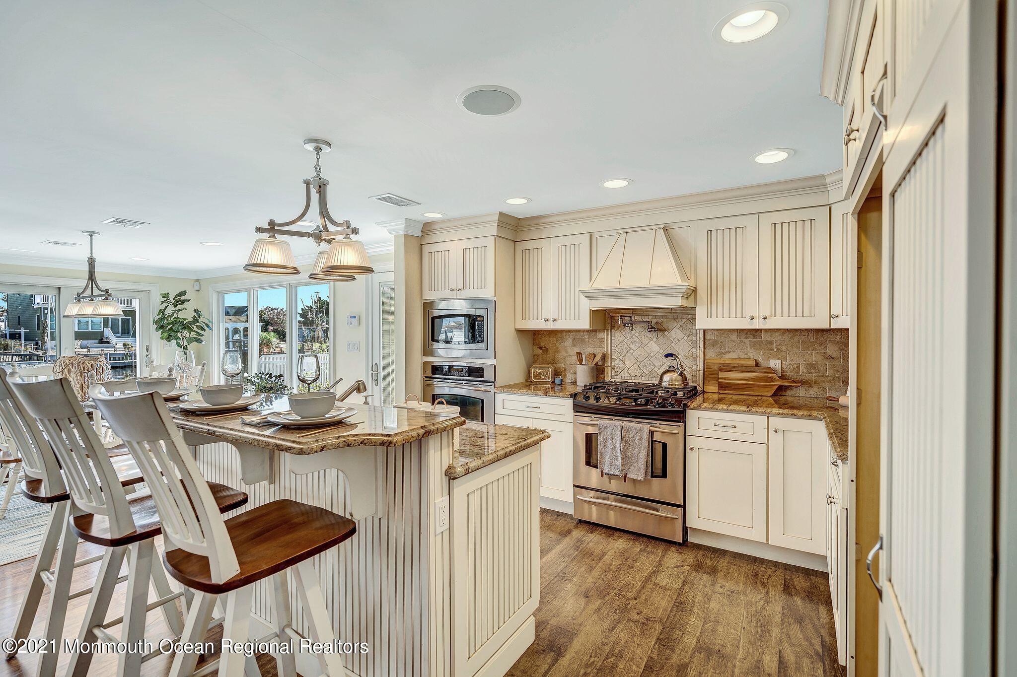 108 Caldwell Road Barnegat, NJ 08005 - Photo 9 of 55 a kitchen with kitchen island a stove a table and chairs in it