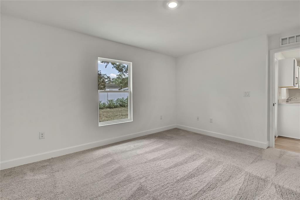 3646 Portillo Road Spring Hill, FL 34608 - Photo 9 of 16 a view of an empty room with a window