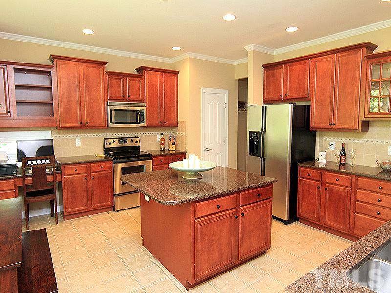 9223 Stone Mountain Road Raleigh, NC 27613 - Photo 2 of 17 a kitchen with stainless steel appliances granite countertop a stove refrigerator sink and cabinets