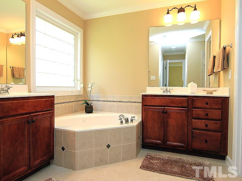 9223 Stone Mountain Road Raleigh, NC 27613 - Photo 12 of 17 a bathroom with a sink vanity and a mirror