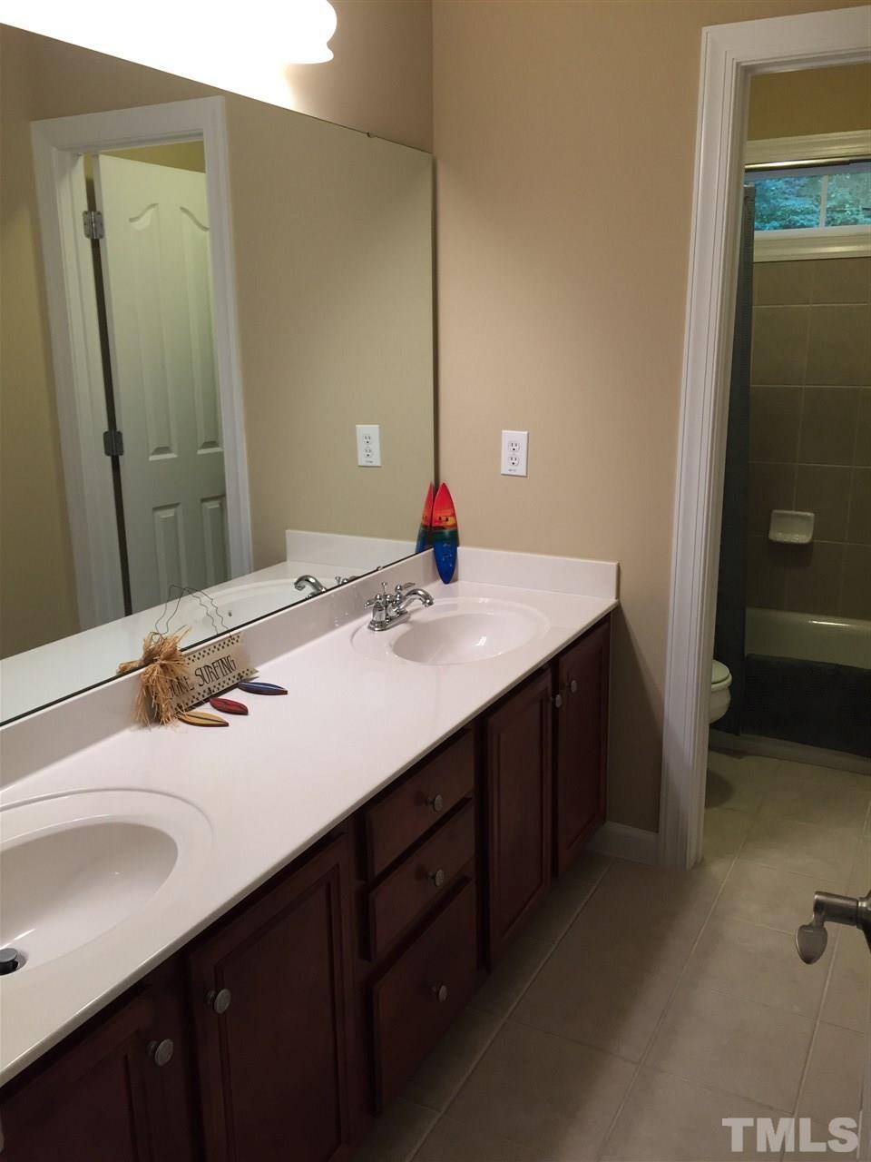 9223 Stone Mountain Road Raleigh, NC 27613 - Photo 14 of 17 a bathroom with a sink and a mirror