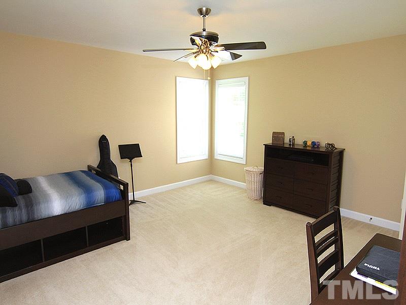 9223 Stone Mountain Road Raleigh, NC 27613 - Photo 16 of 17 a bedroom with a bed and a window