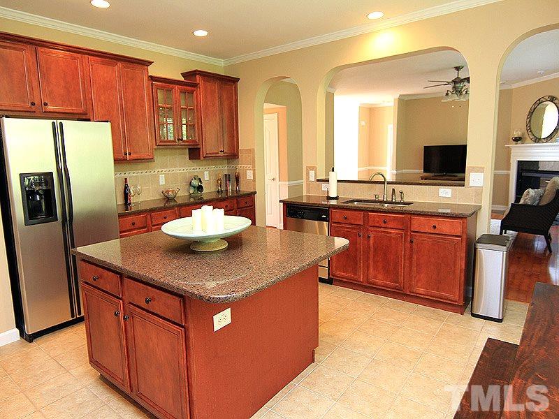 9223 Stone Mountain Road Raleigh, NC 27613 - Photo 3 of 17 a kitchen with stainless steel appliances granite countertop a sink a stove and a refrigerator