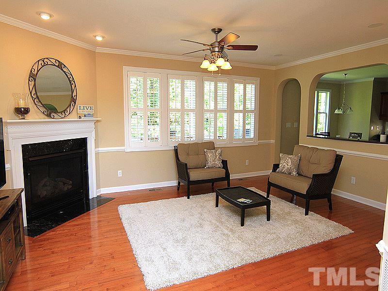 9223 Stone Mountain Road Raleigh, NC 27613 - Photo 6 of 17 a living room with furniture and a fireplace