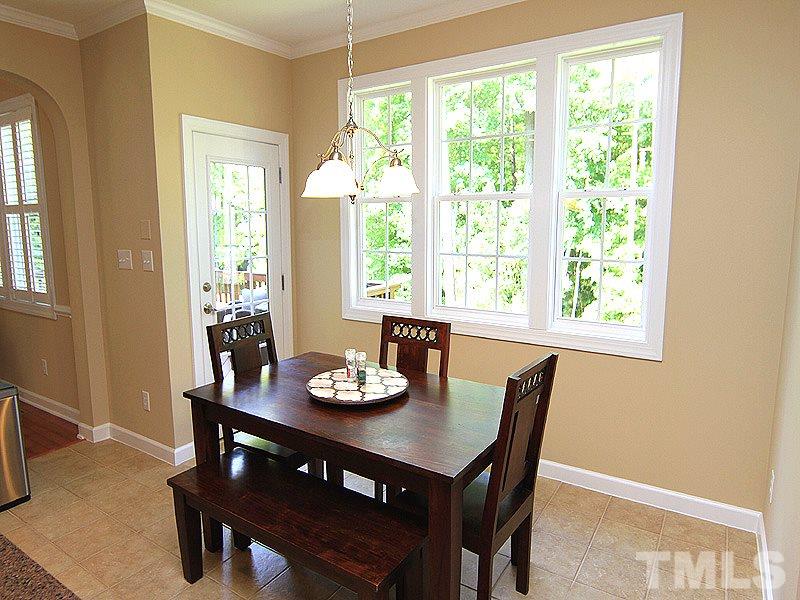 9223 Stone Mountain Road Raleigh, NC 27613 - Photo 8 of 17 a view of a dining room with furniture window and outside view