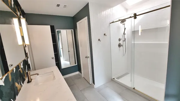 a bathroom with a shower and a sink