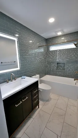 a bathroom with a sink a toilet and mirror