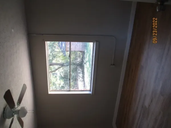 a room with a window and a chair