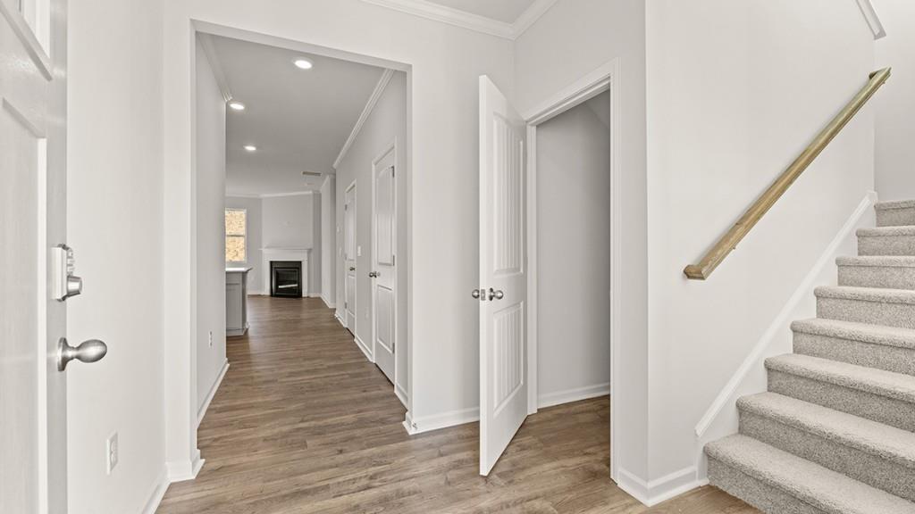 4083 Peregrine Way Gainesville, GA 30506 - Photo 2 of 34 a view of a hallway with the entryway and wooden floor