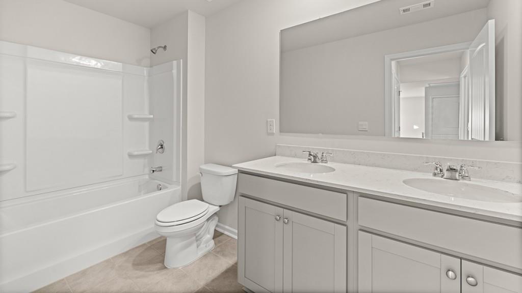 4083 Peregrine Way Gainesville, GA 30506 - Photo 28 of 34 a bathroom with a sink a toilet and shower
