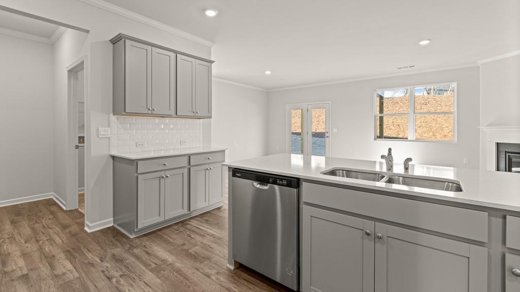 4083 Peregrine Way Gainesville, GA 30506 - Photo 7 of 34 a kitchen with a sink cabinets and wooden floor
