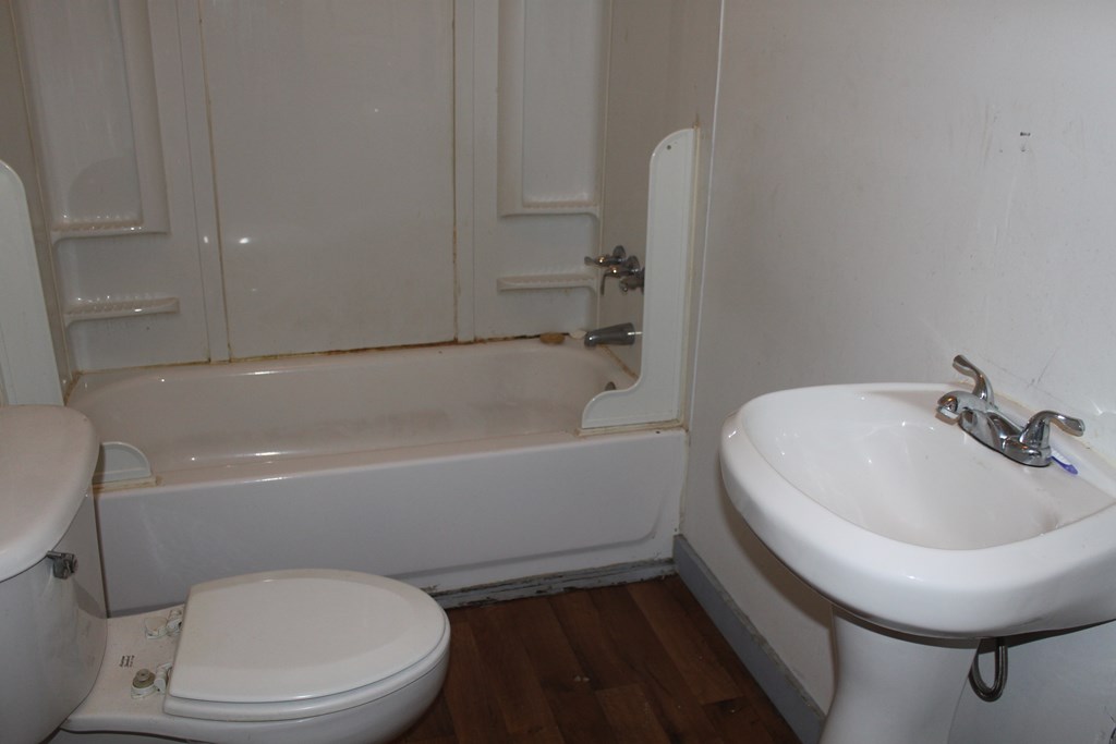 2 Wilson Street Manchester, GA 31816 - Photo 14 of 18 a white toilet sitting next to a bath tub