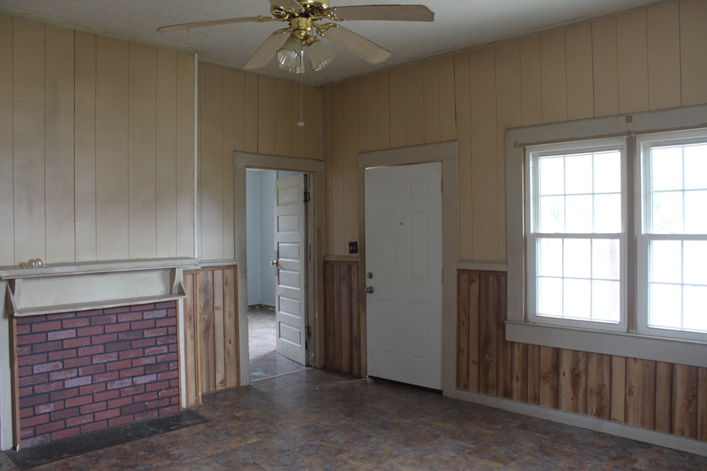 2 Wilson Street Manchester, GA 31816 - Photo 2 of 18 an empty room with chandelier fan and windows