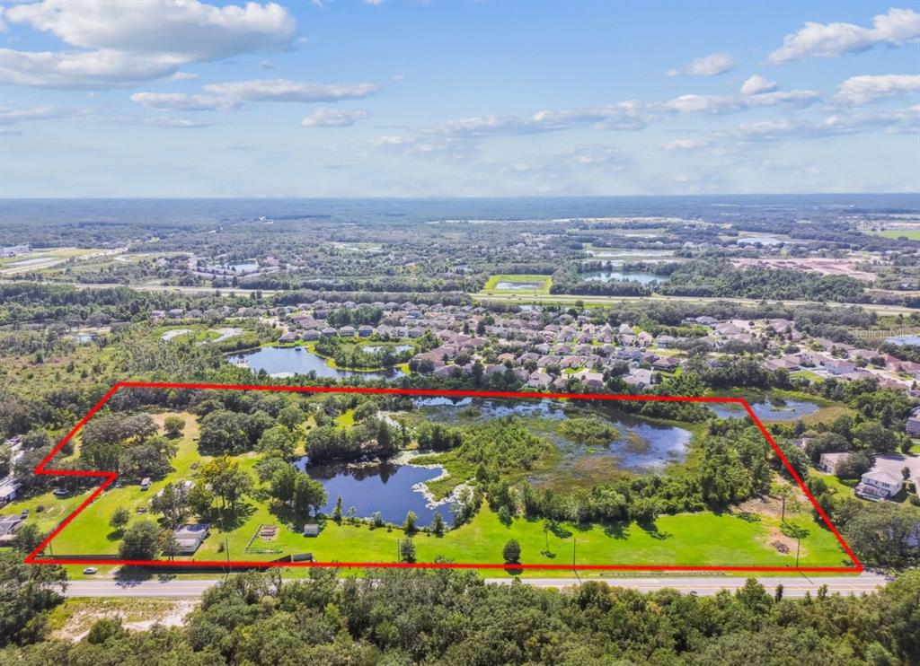12321 Shady Hills Road Spring Hill, FL 34610 - Photo 13 of 30 an aerial view of residential houses with outdoor space and trees
