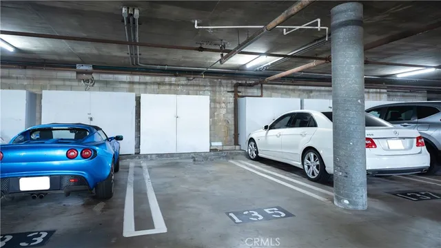 a view of parking garage with cars parked