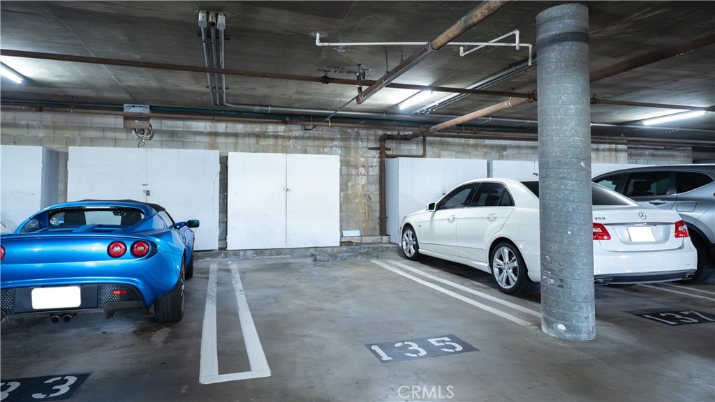 102 Scholz Plaza, Unit 37 Newport Beach, CA 92663 - Photo 11 of 12 a view of parking garage with cars parked