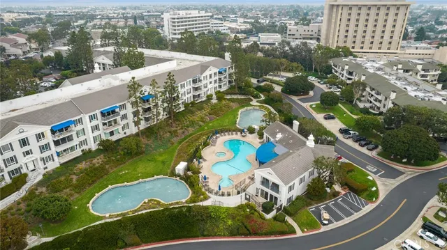 an aerial view of a swimming pool a yard and outdoor seating
