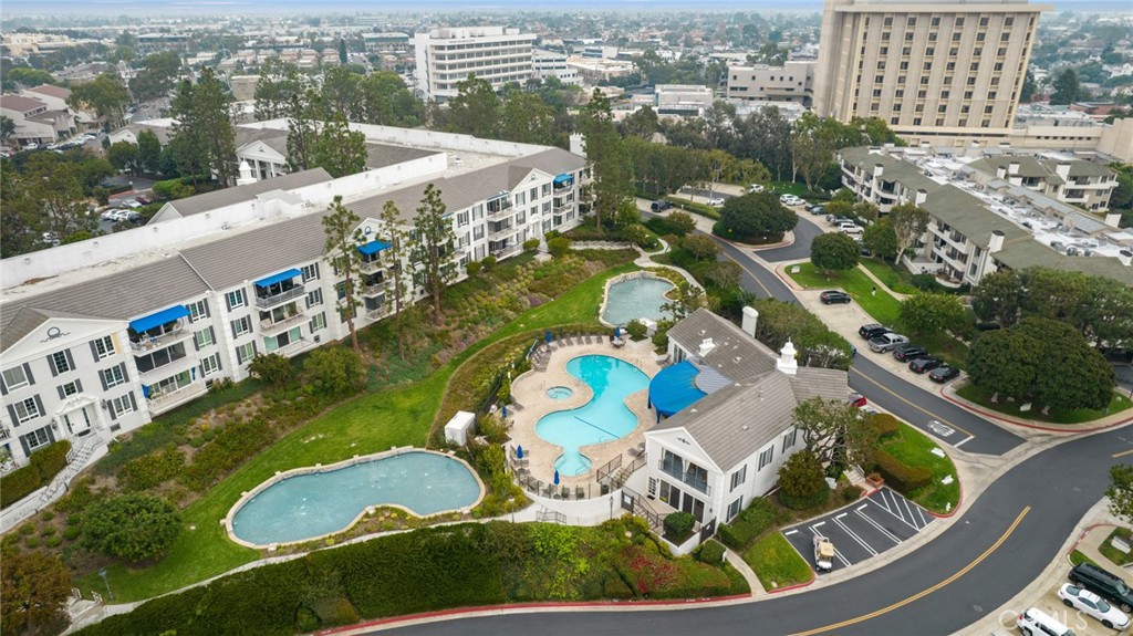 102 Scholz Plaza, Unit 37 Newport Beach, CA 92663 - Photo 12 of 12 an aerial view of a swimming pool a yard and outdoor seating