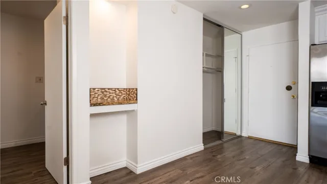 a view of walk in closet with wooden floor