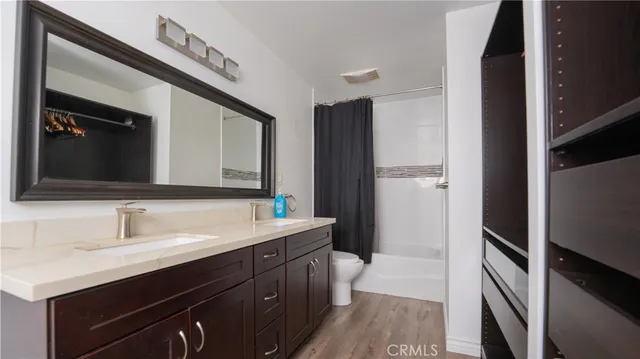 a bathroom with a double vanity sink and mirror