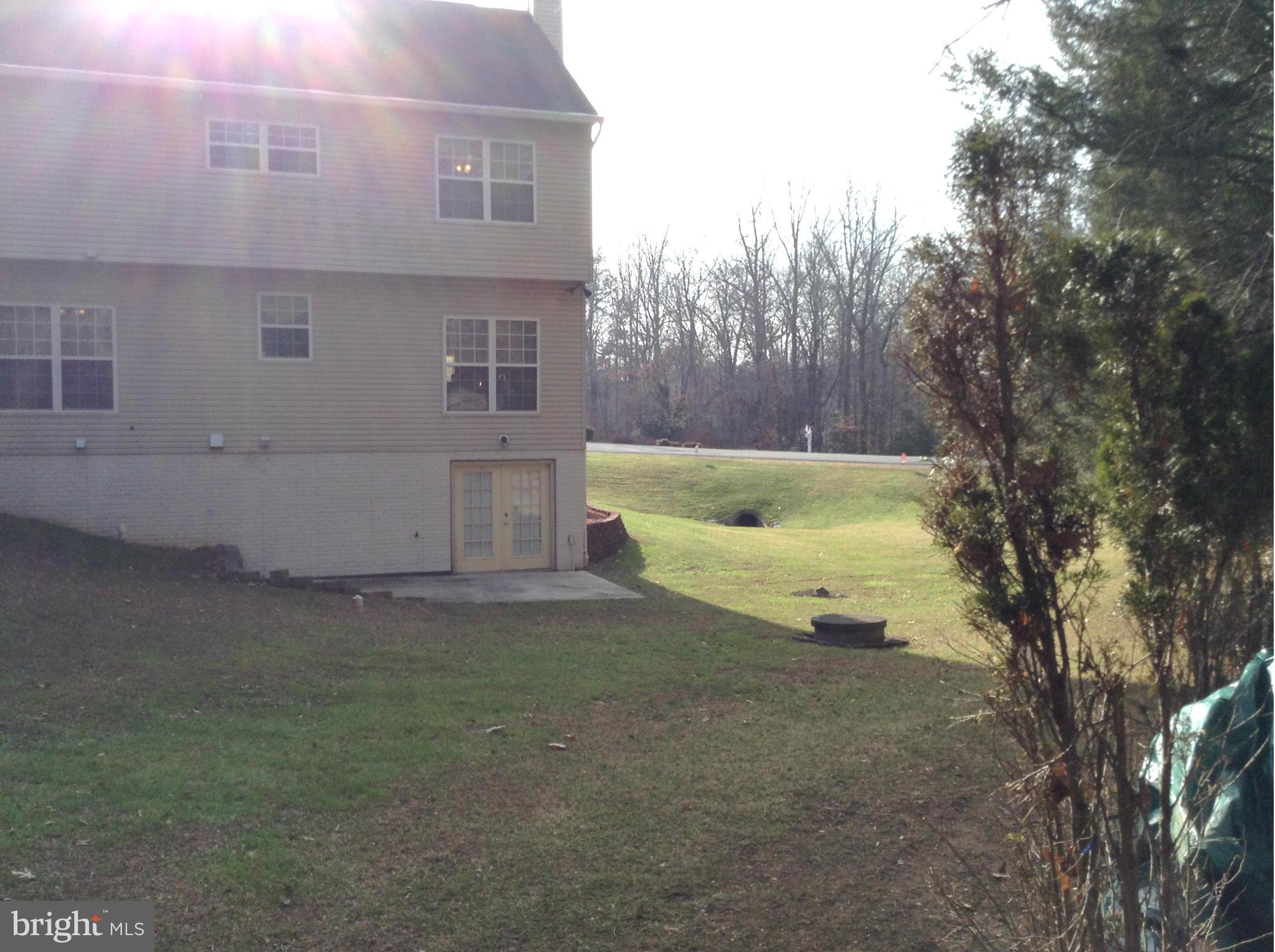 6540 Running Brook Road Manassas, VA 20112 - Photo 11 of 17 a view of a house with backyard and trees