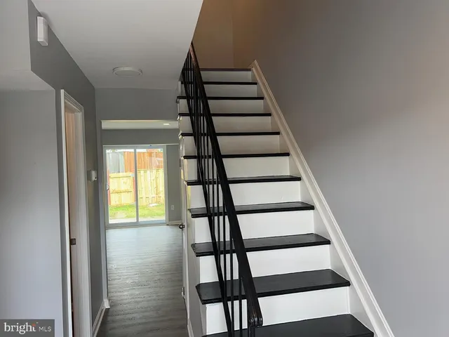 a view of entryway with wooden floor and stairs