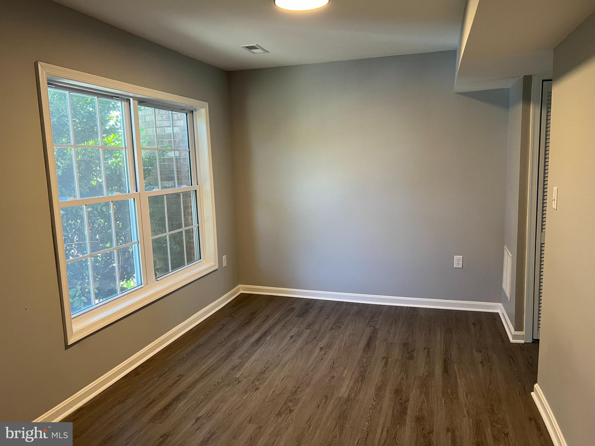 3807 Port Hope Point Triangle, VA 22172 - Photo 22 of 22 a view of an empty room with wooden floor and a window