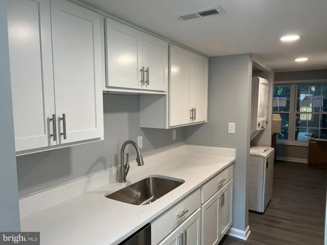 a kitchen that has a sink and cabinets