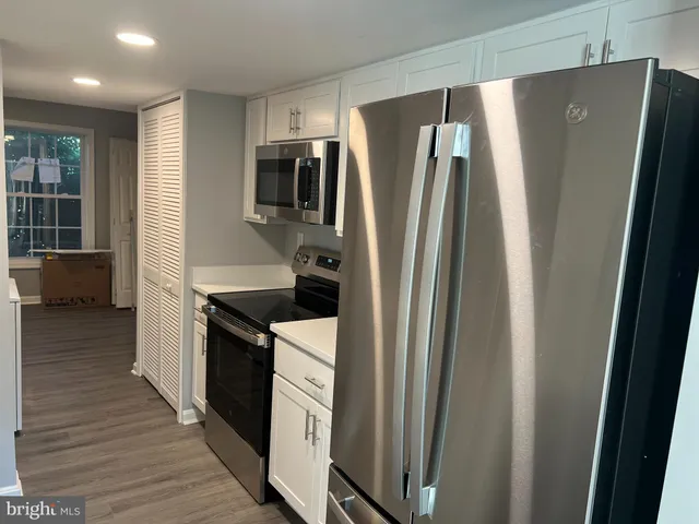 a kitchen with stainless steel appliances a refrigerator and a sink