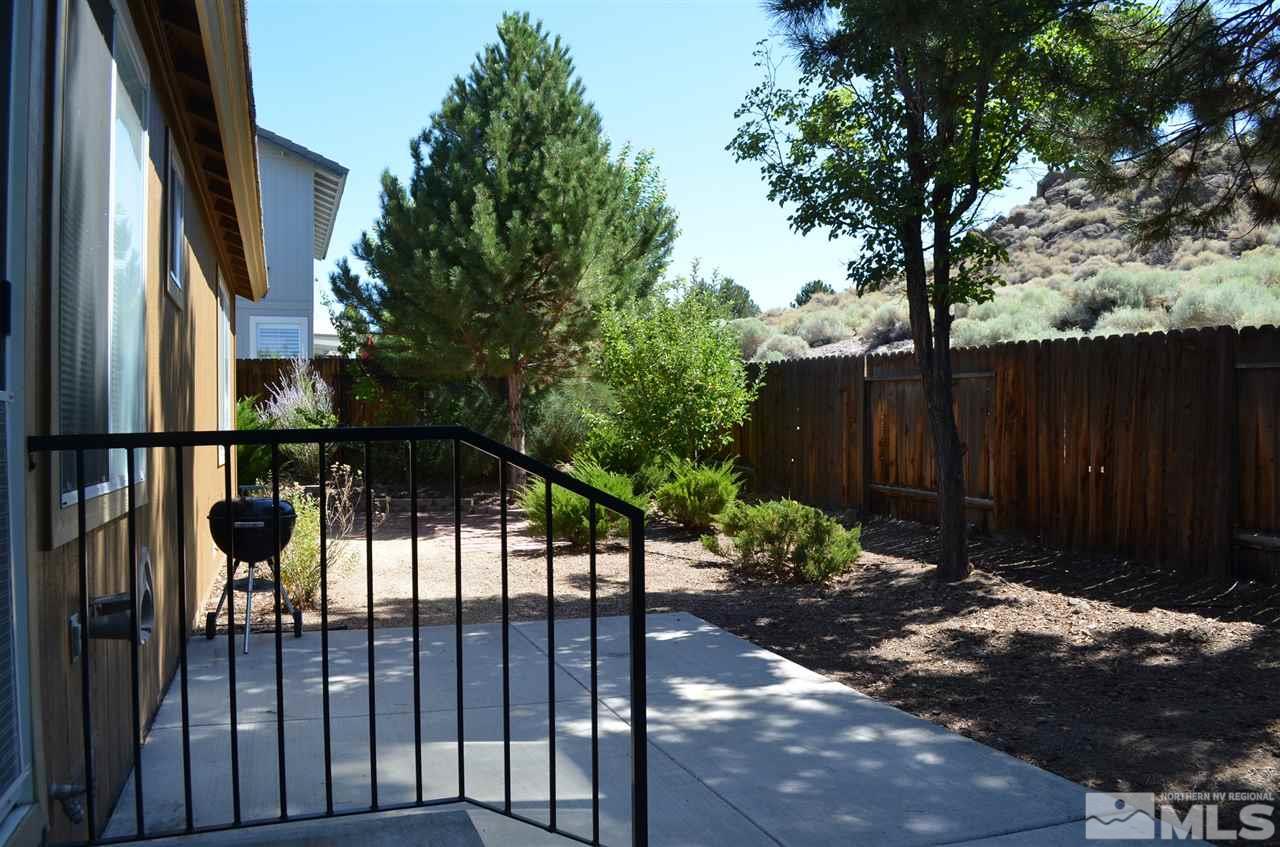4668 Goodwin Road Sparks, NV 89436 - Photo 2 of 13 a view of a backyard with potted plants and large tree