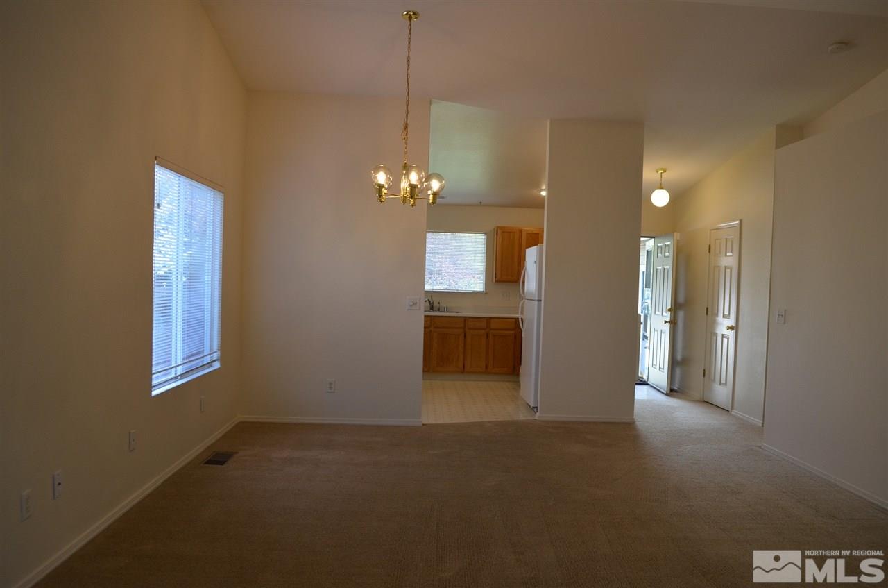 4668 Goodwin Road Sparks, NV 89436 - Photo 5 of 13 a view of a room with a chandelier fan and windows