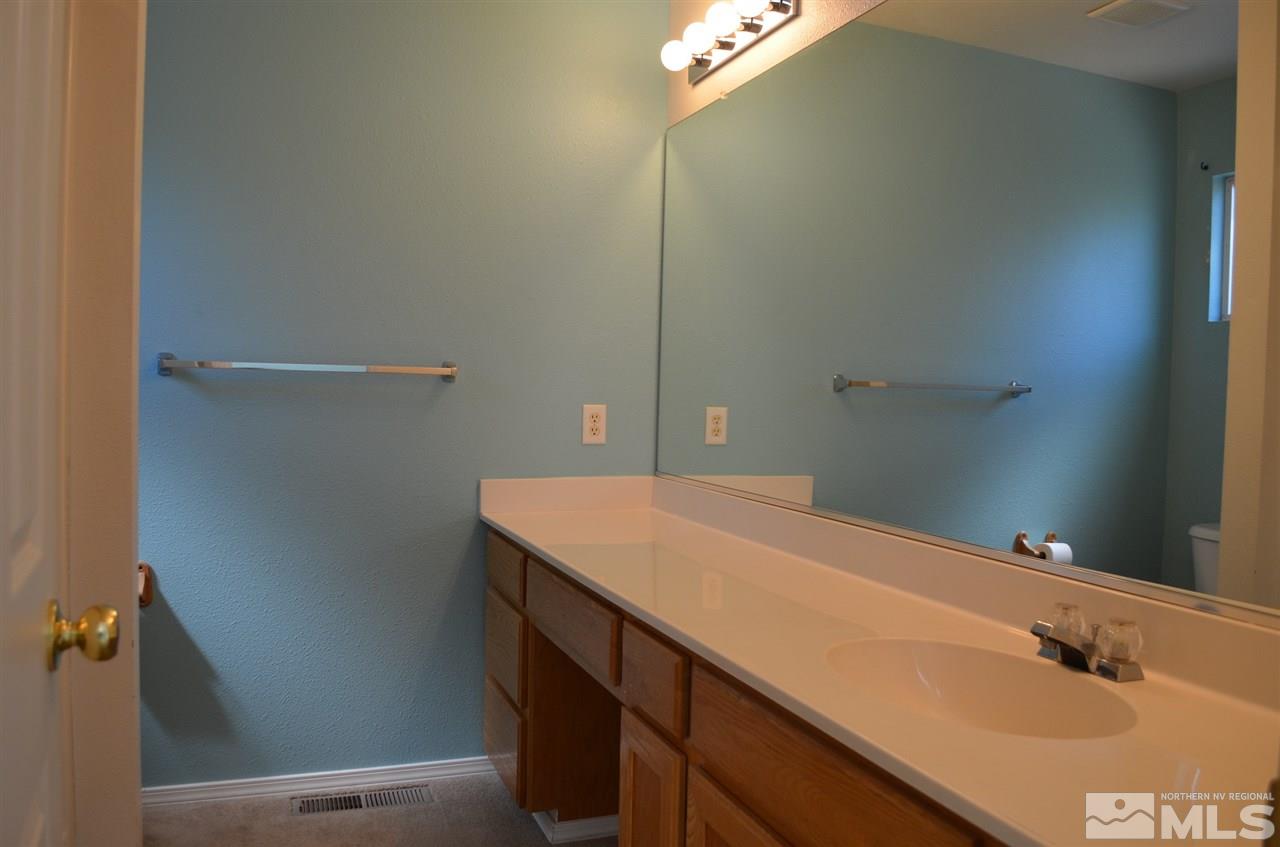 4668 Goodwin Road Sparks, NV 89436 - Photo 9 of 13 a bathroom with a sink and vanity