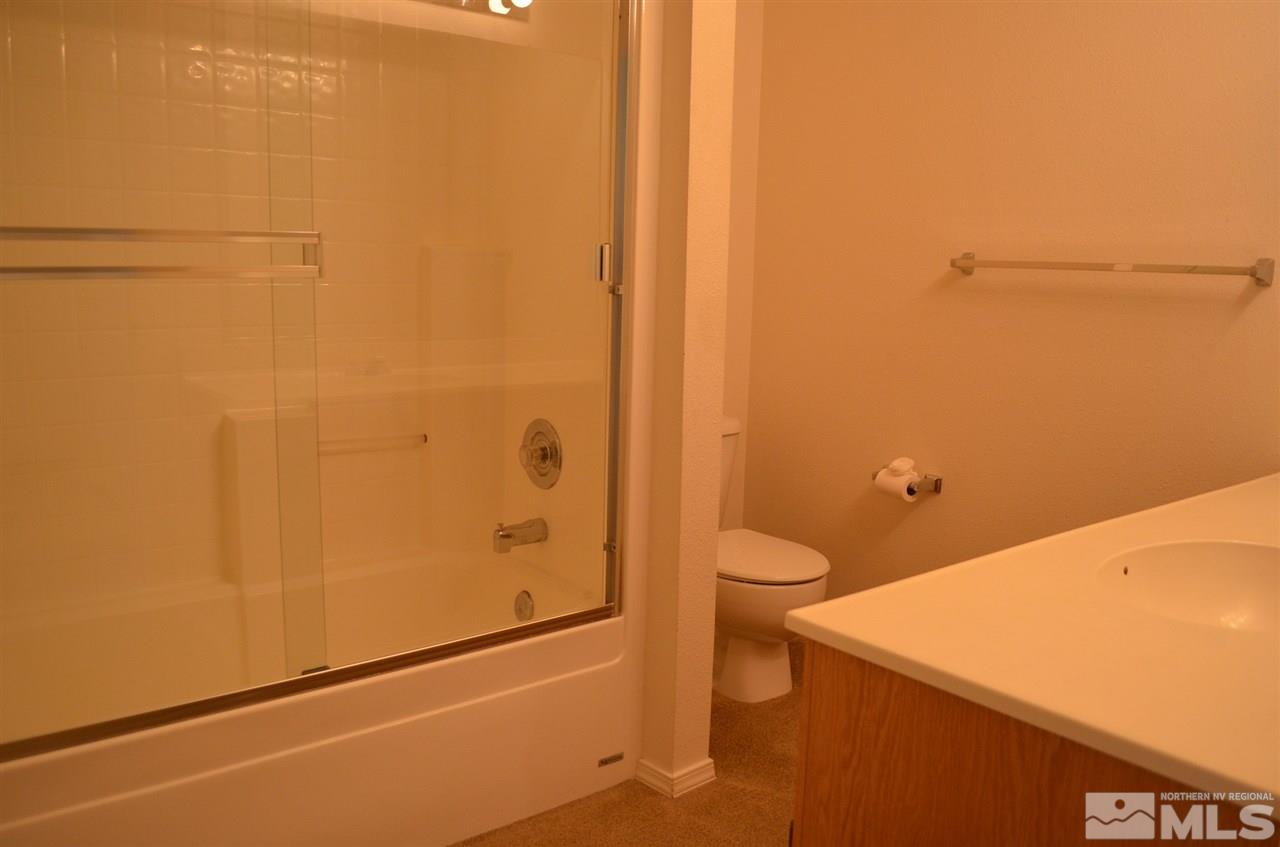 4668 Goodwin Road Sparks, NV 89436 - Photo 10 of 13 a bathroom with a granite countertop sink and a toilet