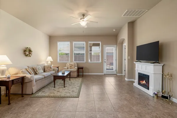 a living room with furniture a flat screen tv and a fireplace