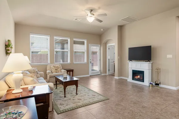 a living room with furniture a fireplace and a flat screen tv