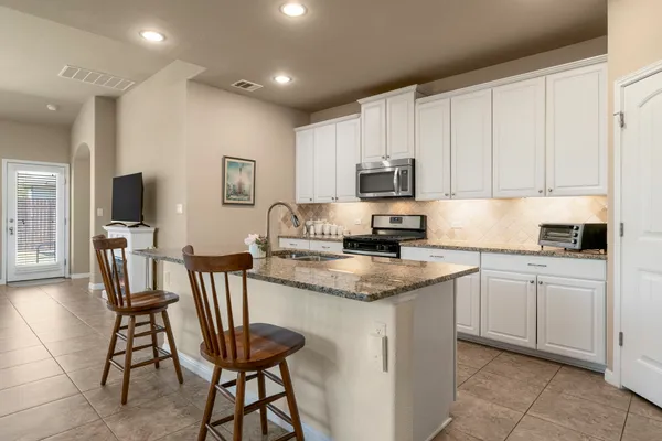 a kitchen with a stove a sink and a refrigerator